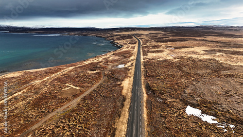 Wonderful road into the endless expanses along the blue green sea in an autumn fauna mood in Iceland