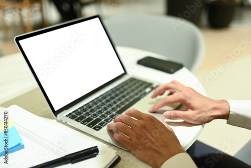 Unrecognizable businessman typing on laptop searching information or working online