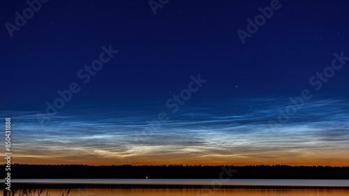 Summer night by the lake with the noctilucent clouds photo