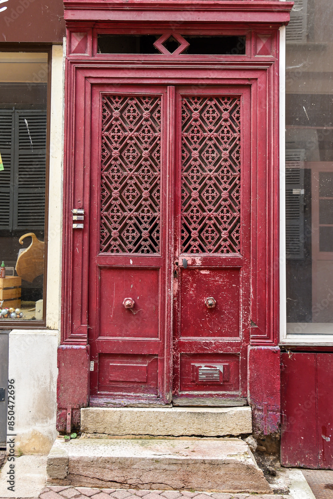 abandoned old reddish door with stone steps in France