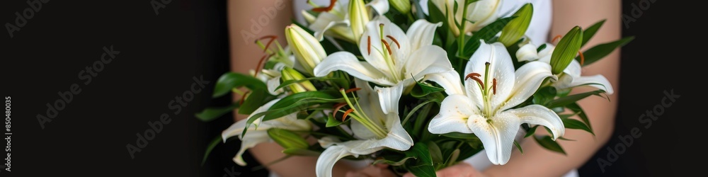 A woman holds a bountiful bouquet of pure white lilies A woman holds a bountiful bouquet of pure white lilies