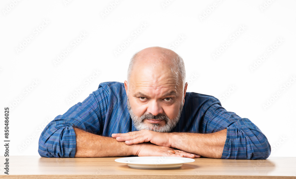 Concept showing Indian asian retired senior old man with empty ceramic plate, holding, presenting or pointing Concept showing Indian asian retired senior old man with empty ceramic plate, holding, presenting or pointing