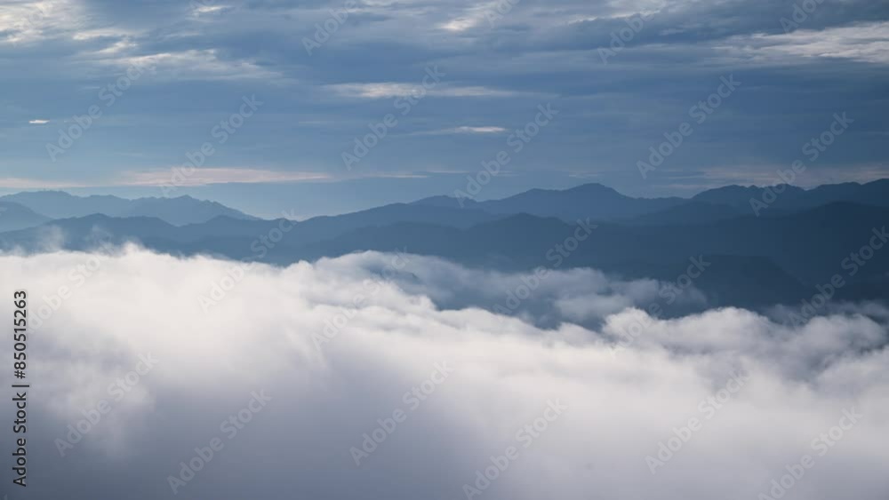 Before sunrise, the unpredictable sea of clouds is like turbulent waves. View of the mountains surrounding Emerald Reservoir. Xindian District, Taiwan. Before sunrise, the unpredictable sea of clouds is like turbulent waves. View of the mountains surrounding Emerald Reservoir. Xindian District, Taiwan.
