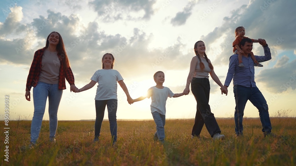 Silhouette of a big family walking at sunset. People child summer concept. Big family walking in nature in the park. Silhouette of a family walking in nature in the park lifestyle at sunset. Silhouette of a big family walking at sunset. People child summer concept. Big family walking in nature in the park. Silhouette of a family walking in nature in the park lifestyle at sunset.