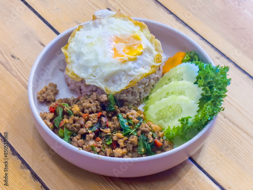 Authentic Thai Basil Chicken Recipe is Stir fried Thai basil with minced pork or chicken served with a fried egg and cooked rices.