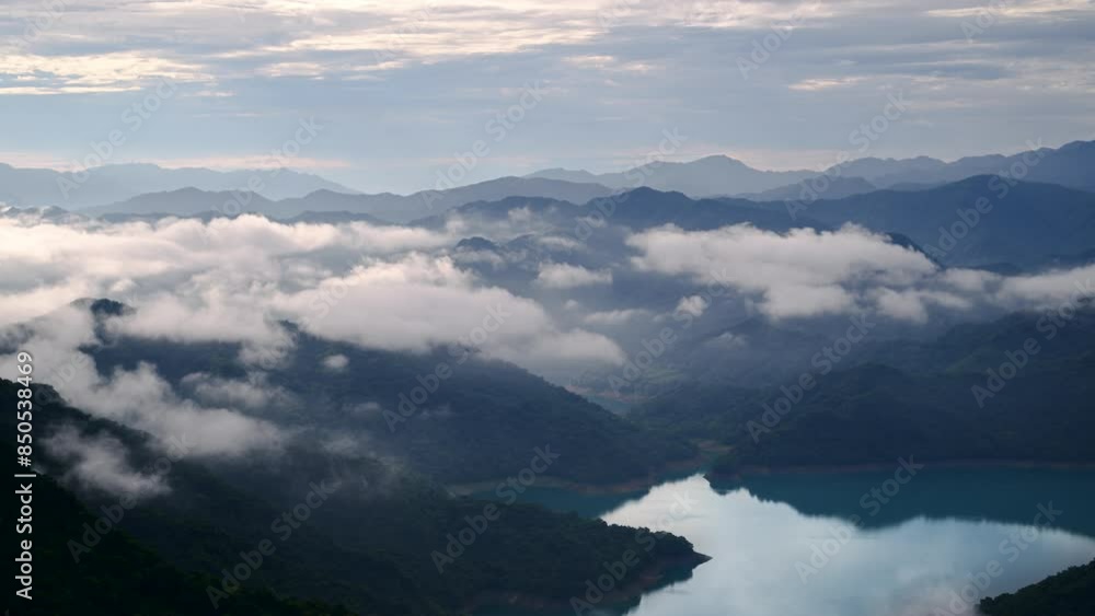 The sea of clouds slowly dispersed, revealing the sapphire blue lake water. View of the mountains surrounding Emerald Reservoir. Xindian District, Taiwan. The sea of clouds slowly dispersed, revealing the sapphire blue lake water. View of the mountains surrounding Emerald Reservoir. Xindian District, Taiwan.