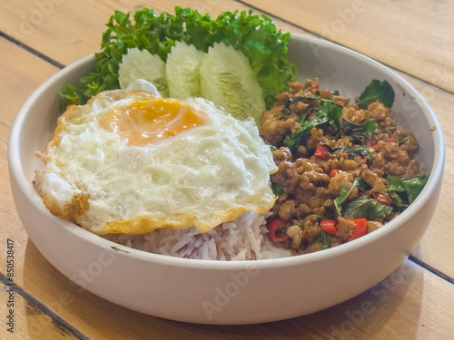 Authentic Thai Basil Chicken Recipe is Stir fried Thai basil with minced pork or chicken served with a fried egg and cooked rices.
