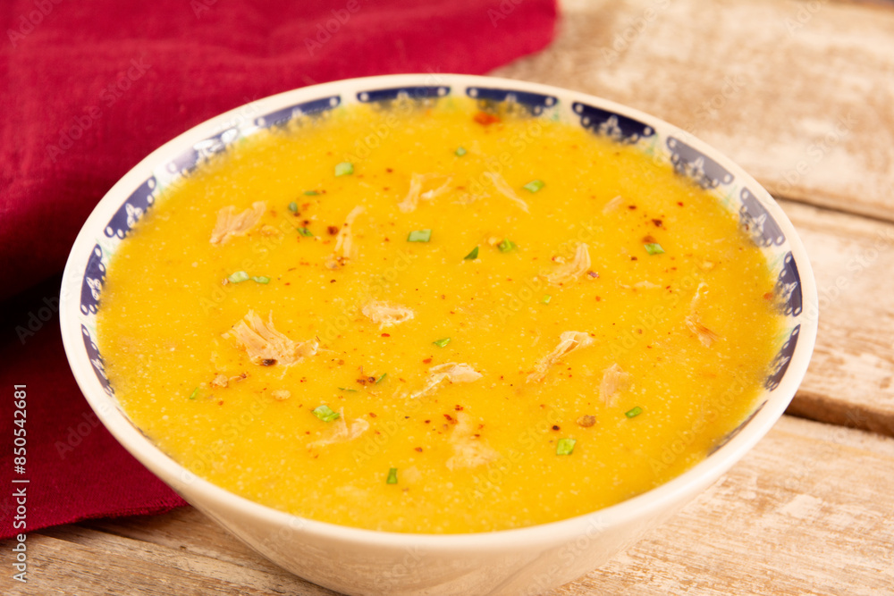 Carrot shredded chicken soup with fresh herbs and pepper Carrot shredded chicken soup with fresh herbs and pepper