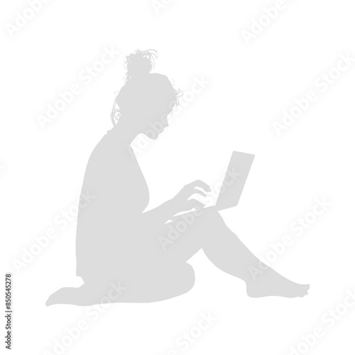 silhouette elderly woman playing on laptop while sitting cross legged