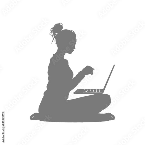 silhouette elderly woman playing on laptop while sitting cross legged