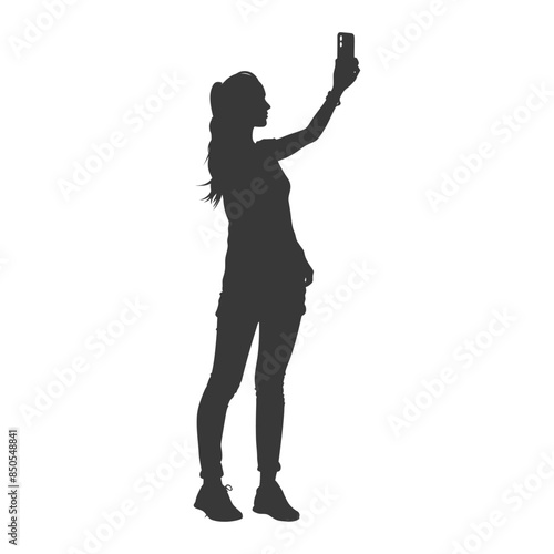 Silhouette: Young woman taking selfie with smartphone, arm raised.