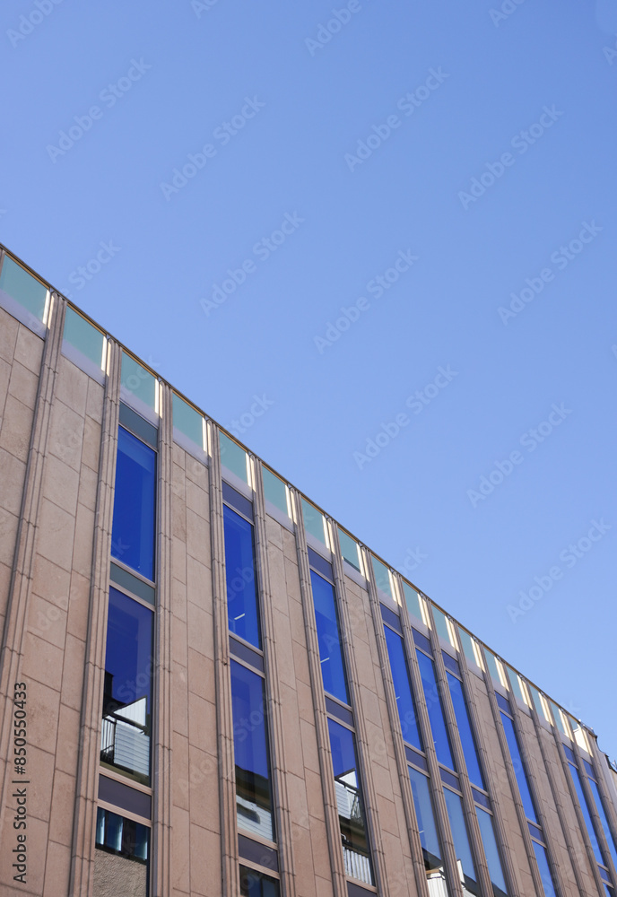 Low angle view of a building against blue sky Low angle view of a building against blue sky