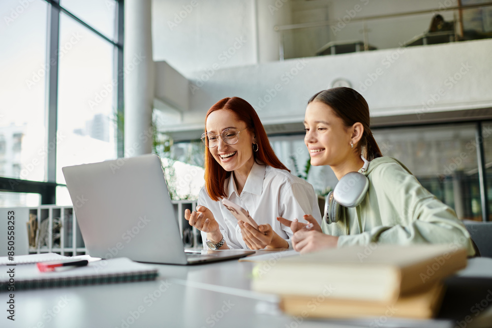 A tutor guides a teenage student through after-school lessons at a desk with a laptop. A tutor guides a teenage student through after-school lessons at a desk with a laptop.