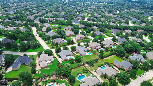 Large lot house with swimming pool, upscale two story suburban single family home lush green trees, Southlake suburbs Dallas Fort Worth metro complex, aerial residential neighborhood urban sprawl photo