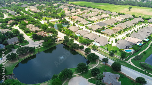 Large vacant land in upscale master planned community with extra-large expensive two-story suburban house with swimming pool, pond near downtown Southlake suburbs Dallas Fort Worth, Texas, aerial © trongnguyen