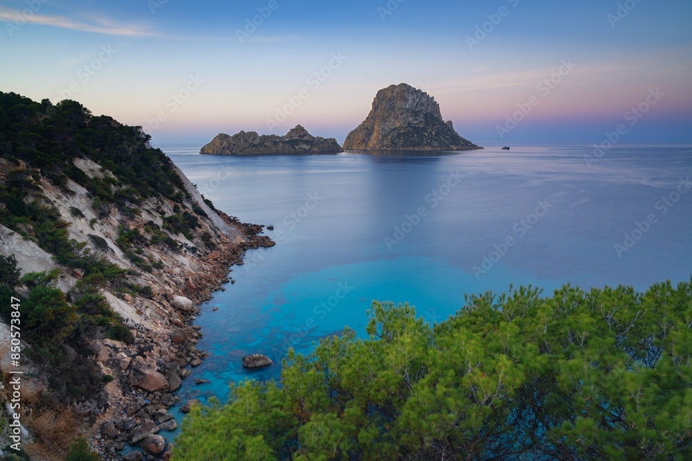 view of the landmark Es Vedra island and rocks off the coast of Ibiza at sunrise view of the landmark Es Vedra island and rocks off the coast of Ibiza at sunrise