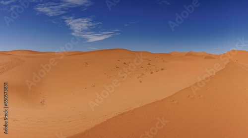 sand dunes in the Sahara Desert of Africa under a blue sky