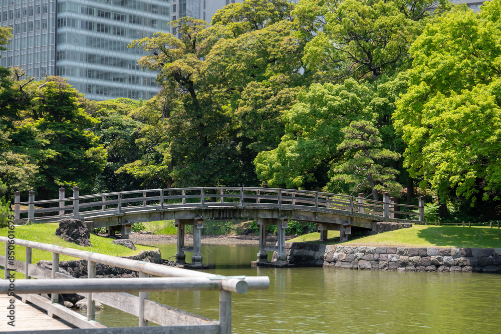 A bridge with an old architectural style surrounded by beautiful trees in Japan A bridge with an old architectural style surrounded by beautiful trees in Japan