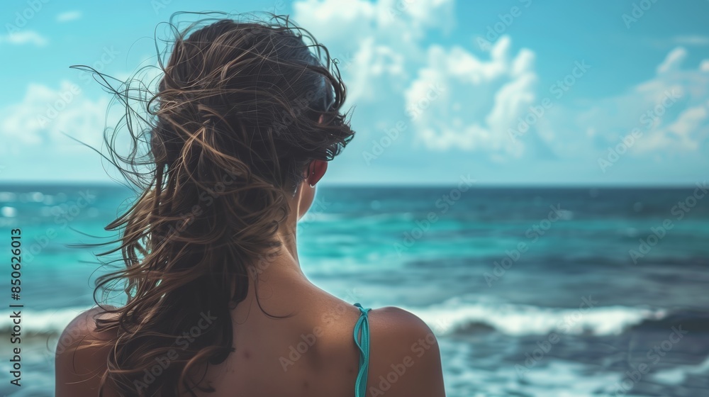 Rear view of a woman looking at the sea. Rear view of a woman looking at the sea.