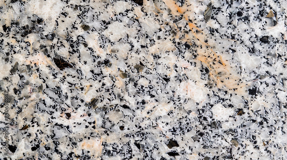 Close-up of granite, soft morning light, speckled surface with mixed mineral colors. Close-up of granite, soft morning light, speckled surface with mixed mineral colors.