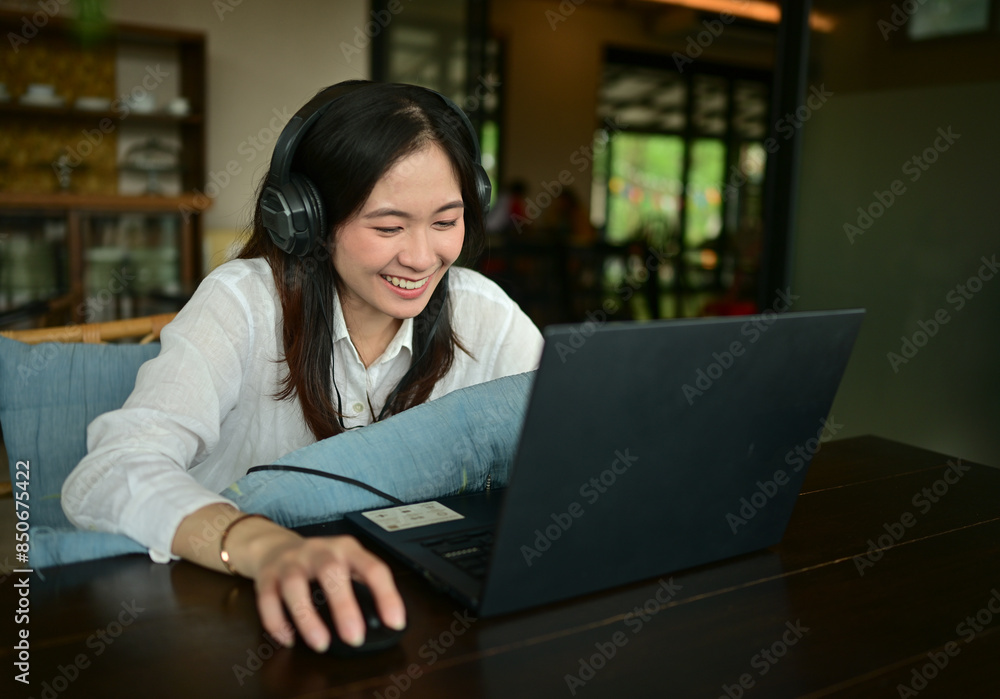 Young Asian business woman is working with a tablet in a coffee shop. Young Asian business woman is working with a tablet in a coffee shop.