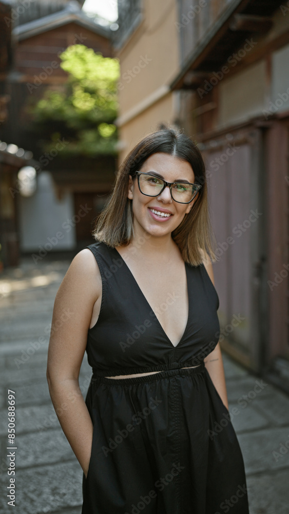 Confident hispanic woman, beautiful and joyful, cheerfully posing with glasses on, standing and smiling on kyoto's traditional streets, radiating natural and carefree latin expression. Confident hispanic woman, beautiful and joyful, cheerfully posing with glasses on, standing and smiling on kyoto's traditional streets, radiating natural and carefree latin expression.