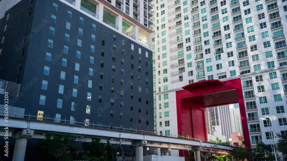 The people mover in Miami, Florida, USA passing a moderne building. A time lapse clip The people mover in Miami, Florida, USA passing a moderne building. A time lapse clip