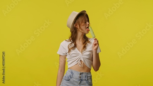 Young woman in casual clothing and hat smiling eating ice cream. Travel, summertime vacation, tourism leisure time concept.
