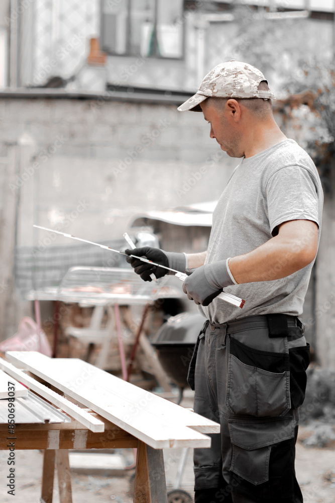 Young builder with a construction measuring tape in his hands. Young builder with a construction measuring tape in his hands.