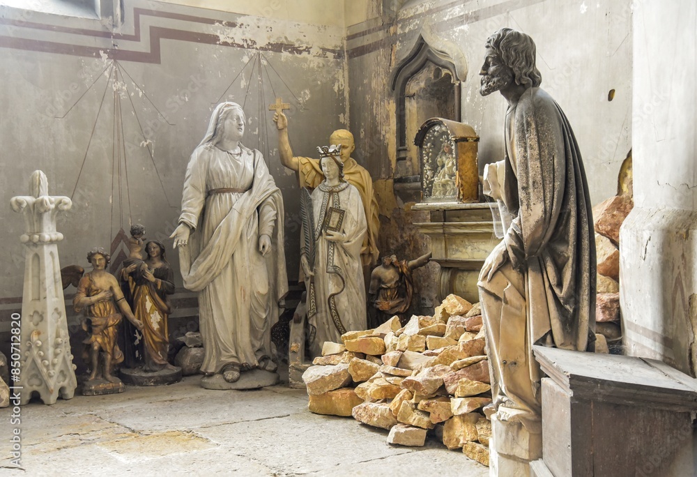 Room inside a church with old broken statues and stones