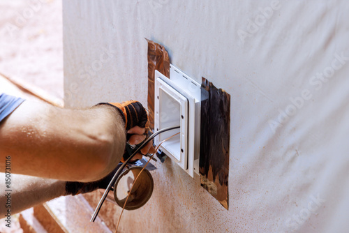 Weatherproof deep plastic electrical box is mounted on outside wall