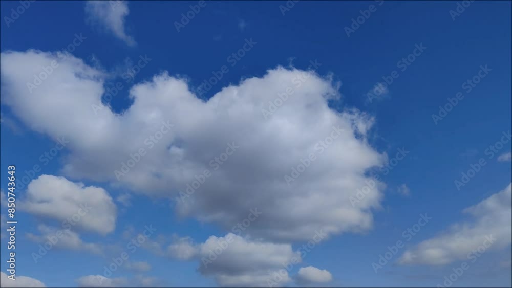 Forming cumulus clouds moving in early blue sky Forming cumulus clouds moving in early blue sky