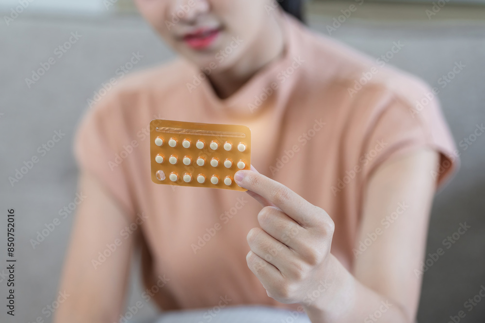 Obraz premium Young Woman Holding Birth Control Pill Pack, Close-Up of Hand and Medication, Contraceptive Health Care, Family Planning, Modern Lifestyle, Women's Health, Medical Choice, Responsible Parenthood