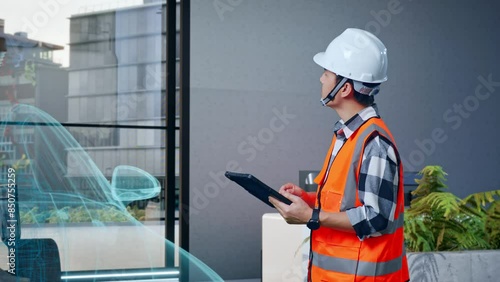 Wallpaper Mural Side View Of Asian Male Engineer With Safety Helmet Looking At The Tablet In His Hand And Looking Around While Standing With Concept of Electric Vehicle, High-tech Industrial Facility Torontodigital.ca