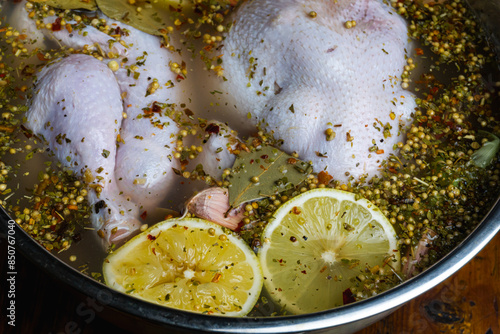 Photos Soaking the chicken in a brine solution using lemon, herbs and aromatic