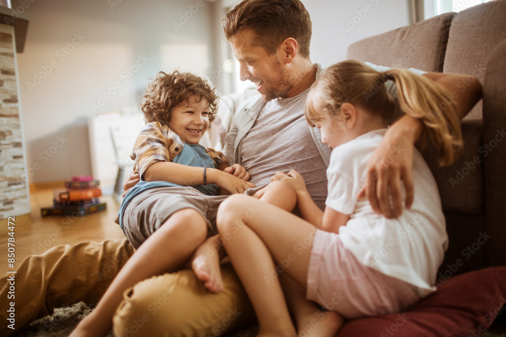 Happy father playing with son and daughter at home Happy father playing with son and daughter at home