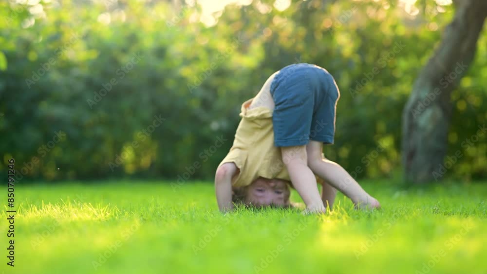 Adorable little boy having fun outdoors in a backyard on sunny summer day. Adorable little boy having fun outdoors in a backyard on sunny summer day.