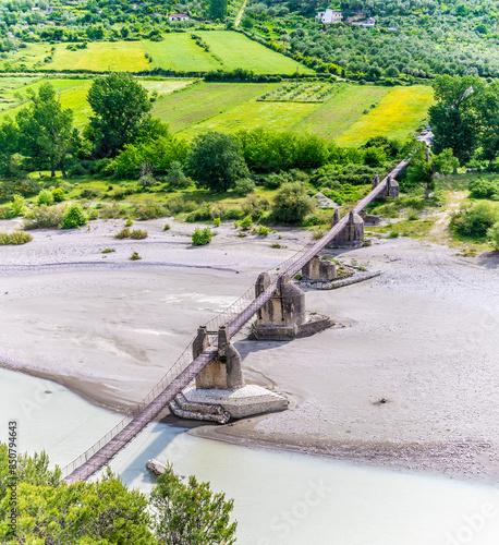 An aerial view of the Ali Pasha Bridge over the Vjosa river in Tepelena, Albania in summertime photo