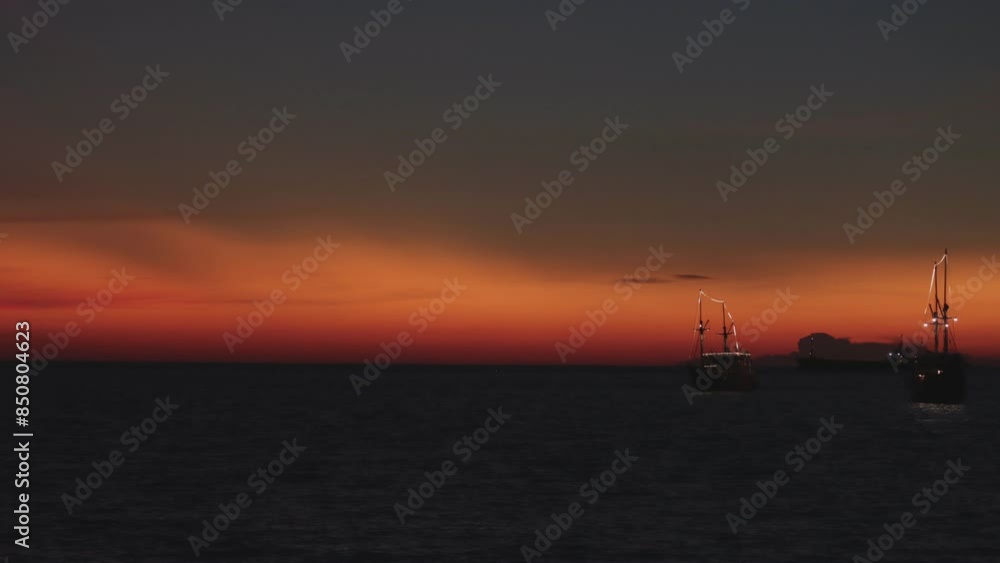 Time lapse of the silhouette of two phinisi boats against the background of the twilight sky Time lapse of the silhouette of two phinisi boats against the background of the twilight sky