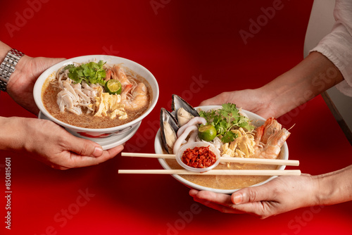 Obraz na plátne hand on Sarawak Laksa, a spicy and flavorful dish that originates from the Malaysian state of Sarawak