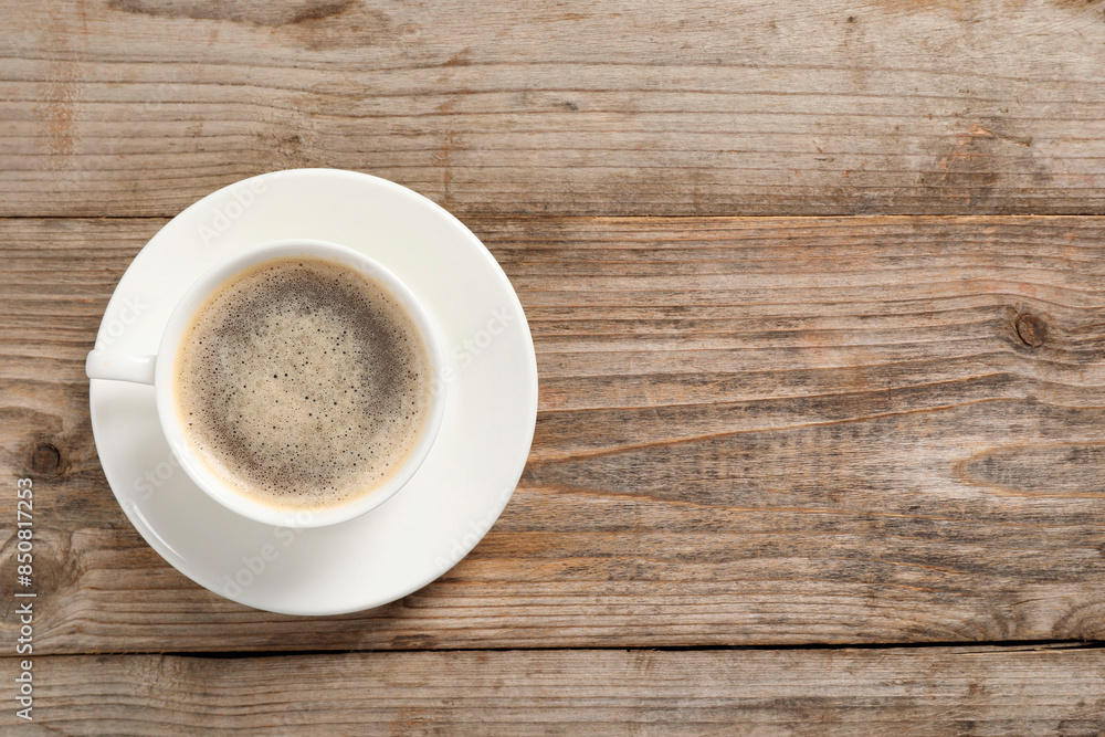 Tasty coffee in cup on wooden table, top view. Space for text Tasty coffee in cup on wooden table, top view. Space for text
