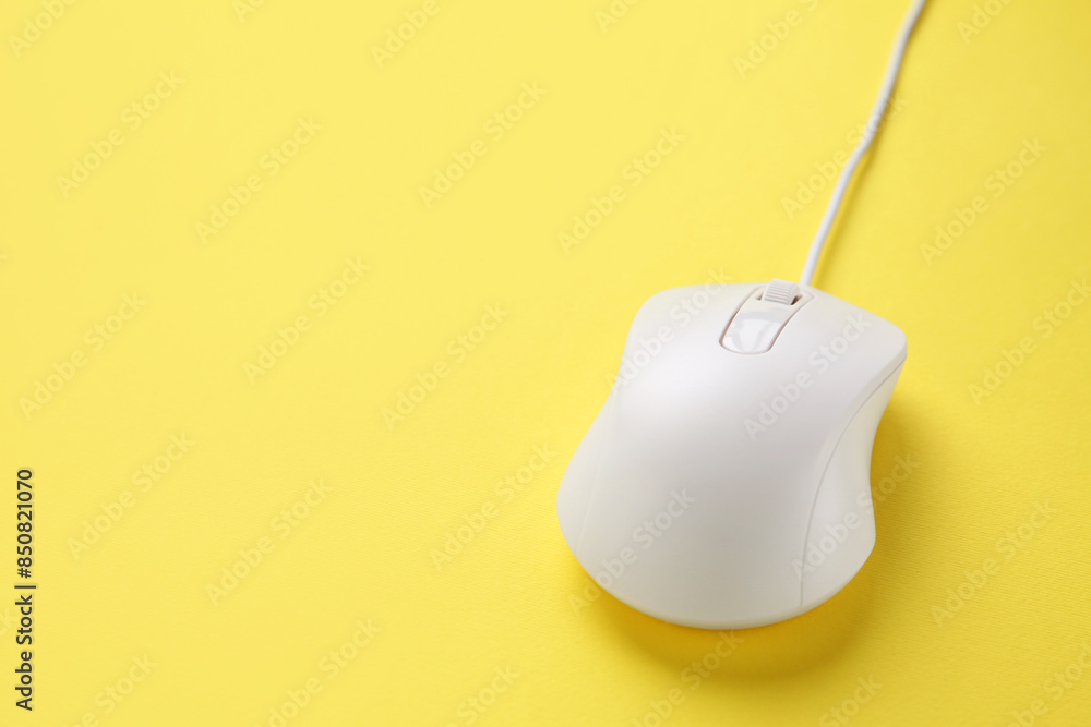 One wired mouse on yellow background, closeup. Space for text One wired mouse on yellow background, closeup. Space for text