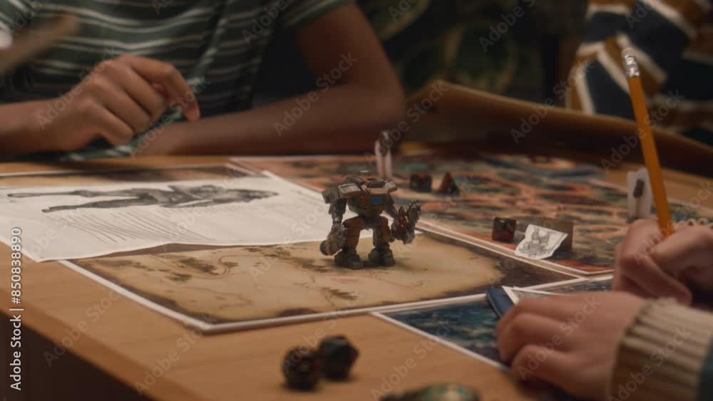 Midsection shot of group of unrecognizable kids playing tabletop game. Making move with action figure and rolling dice indoors Midsection shot of group of unrecognizable kids playing tabletop game. Making move with action figure and rolling dice indoors