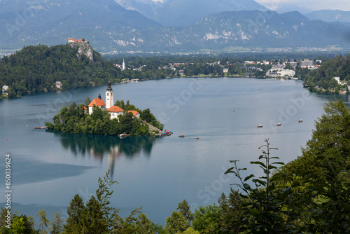 Panoramic view from Lake Bled, beauty heritage in Slovenia. Island with church and castle in the background create a dream setting. View from Ojstrica and Mala Osojnica with the heart-shaped bench. photo