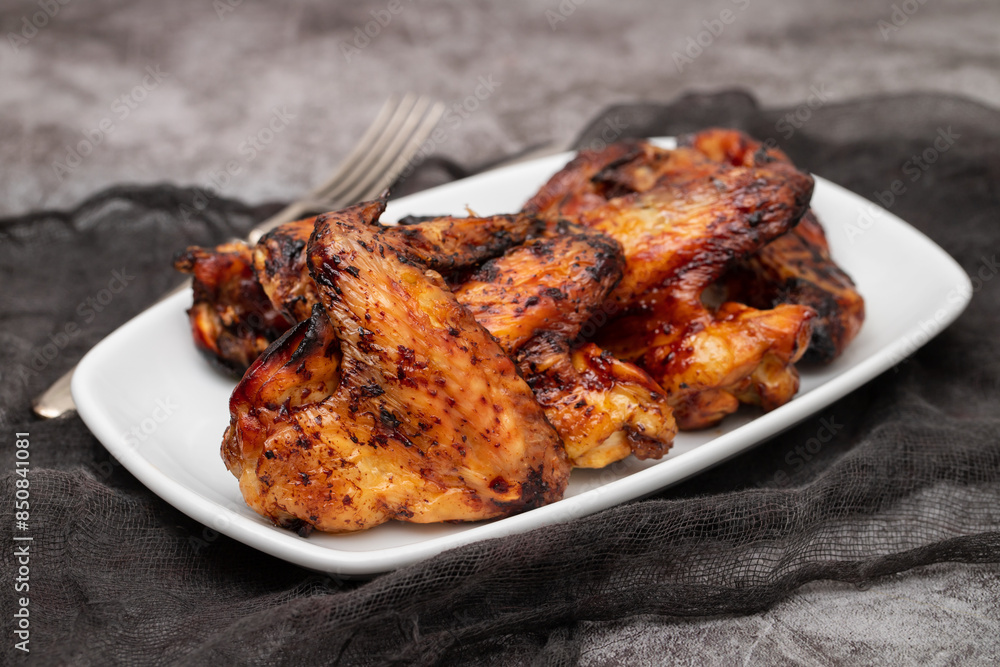 Baked chicken wings with sweet chili sauce in a plate. Baked chicken wings with sweet chili sauce in a plate.