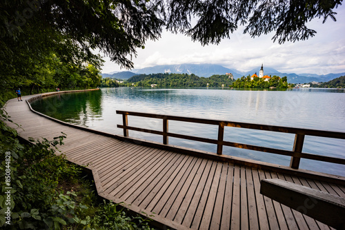 Panoramic view from Lake Bled, beauty heritage in Slovenia. Island with church and castle in the background create a dream setting. View from Ojstrica and Mala Osojnica with the heart-shaped bench.