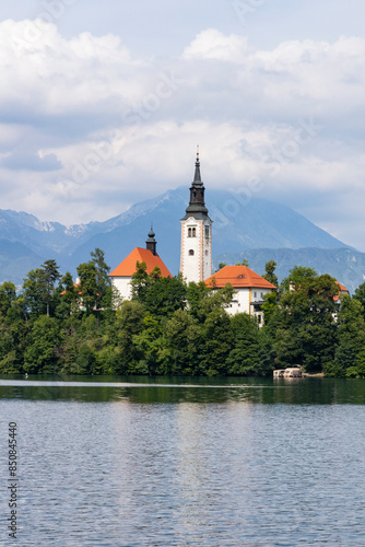 Panoramic view from Lake Bled, beauty heritage in Slovenia. Island with church and castle in the background create a dream setting. View from Ojstrica and Mala Osojnica with the heart-shaped bench.