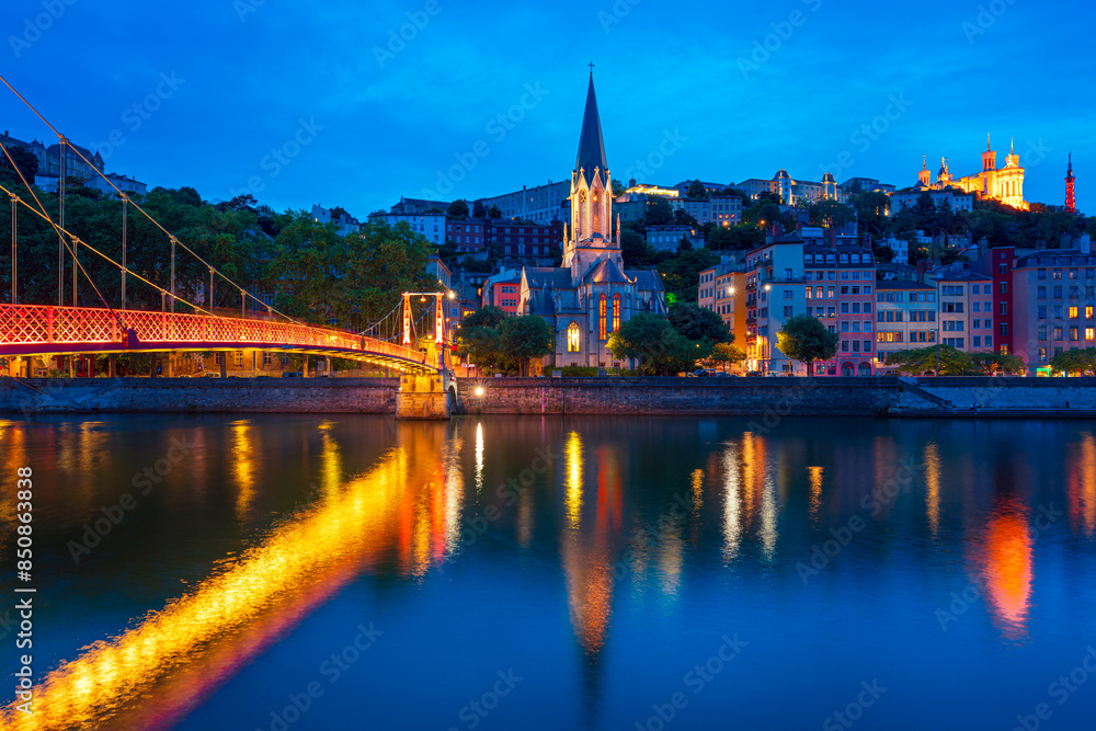 Obraz premium Lyon, France. View at night of the Vieux Lyon District and the Fourviere Hill on the right side of the Saone River