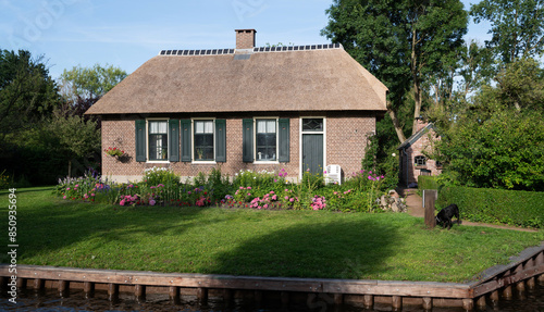 Famous village is know as "Venice of the North" Giethoorn, Netherlands. Village with canals and rustic thatched roof houses. The beautiful houses and gardening.