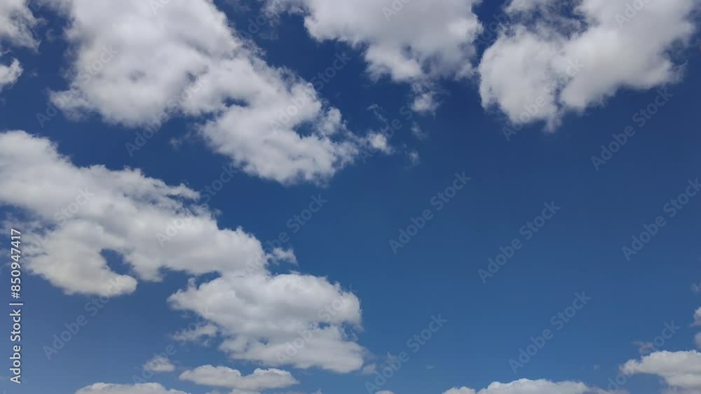 The sun's rays are visible in the sky with several white clouds The sun's rays are visible in the sky with several white clouds